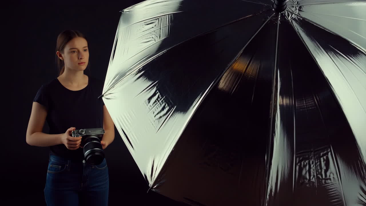 Young Woman Photographer with Camera and Studio Umbrella