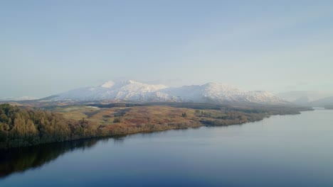 sunrise aerial shot of a snowy capped ben cruachan, a mountain in argyll and bute, scotland