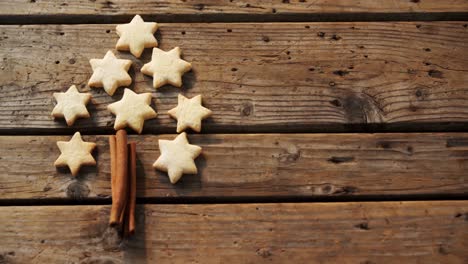 Christmas-cookies-and-cinnamon-sticks-on-wooden-table-4k