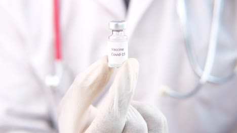 doctor holding a covid-19 vaccine vial