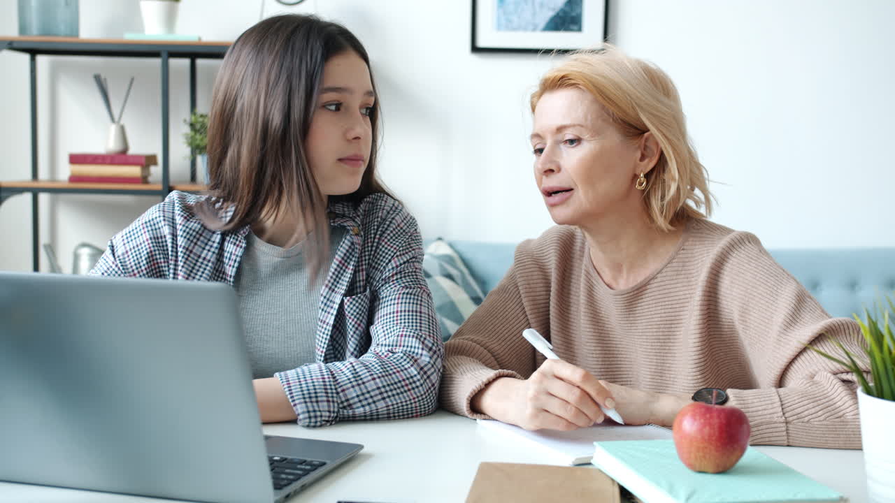 Teenage Girl Getting Help with Homework from her Mother