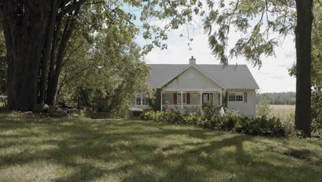 gorgeous backyard garden with a rope swing with a white house in the distance