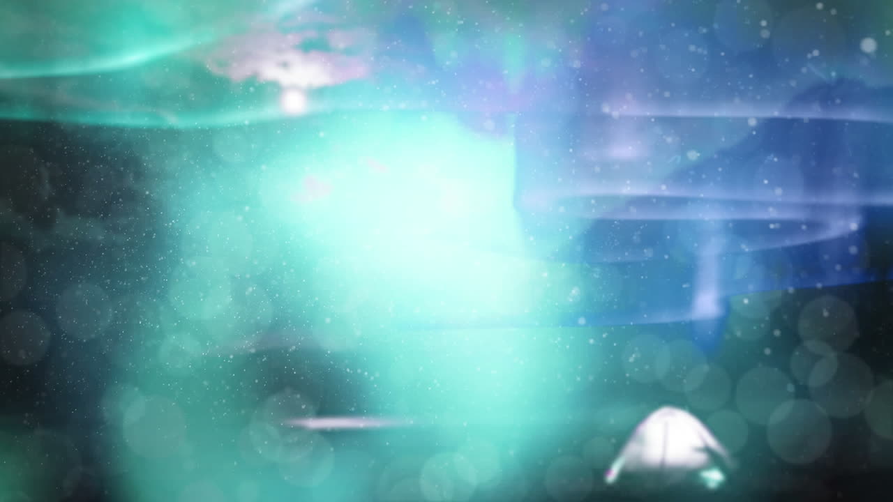 animación digital de la nieve cayendo contra manchas verdes de luz contra un fondo azul