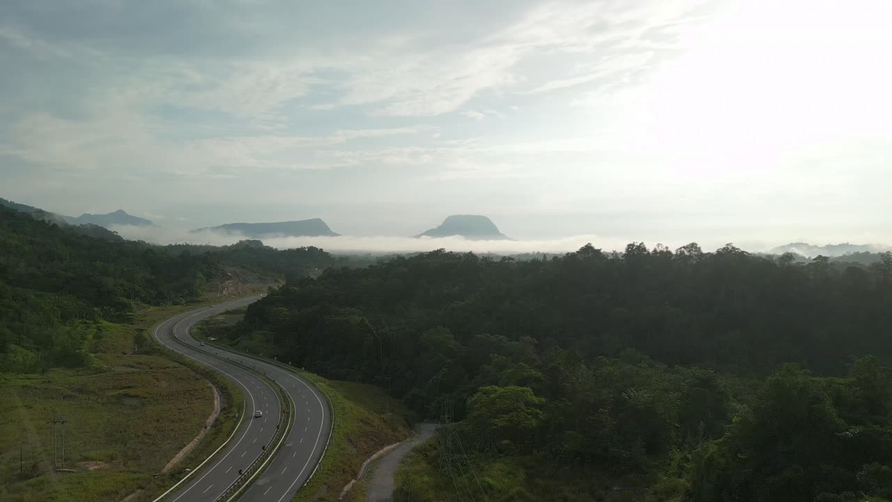 Beautiful Drone View Of Bau To Lundu Pan Borneo Highway During Morning Sunset With Mountain And Valley, Green Forest,Sarawak, Borneo.