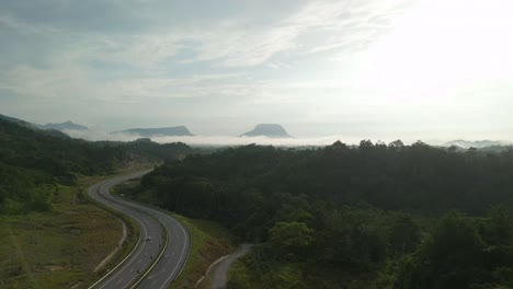 beautiful drone view of bau to lundu pan borneo highway during morning sunset with mountain and valley, green forest,sarawak, borneo.