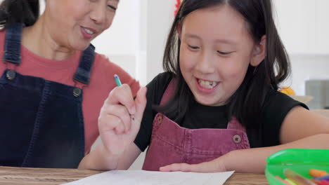 grandmother helping granddaughter with homework