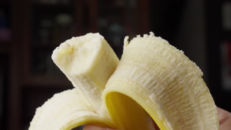 person eating fresh tropical banana fruit. close-up shot