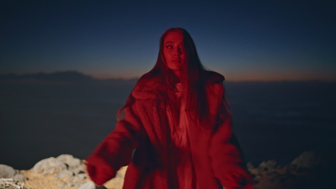 Neon woman dancing sunset party in light closeup. Girl enjoying time music