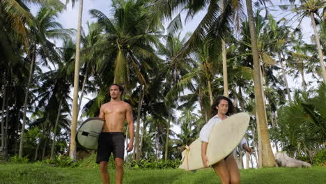 surfers walking with surfboards