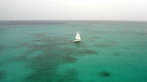 Vista-Aérea-Del-Velero-En-El-Mar-Tropical-Abierto-Navegando-Hasta-El-Horizonte,-Disparo-De-Drones