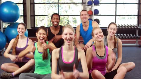 fit people smiling at camera in gym