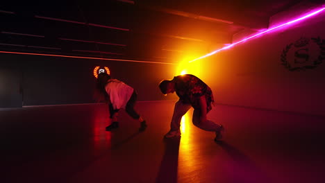 couple dancing in a neon-lit studio