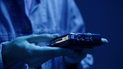 person holding a vintage cassette tape player