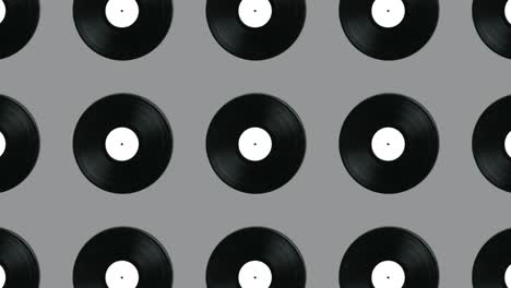 Geometric pattern with retro vinyl disks on a gray background. Minimal motion graphics music animation concept