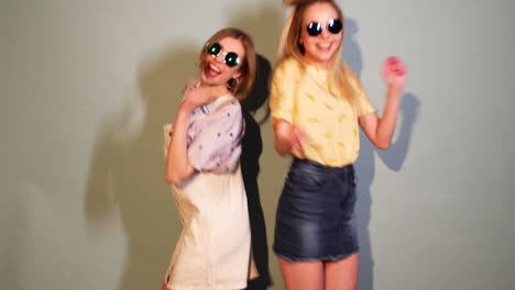 two girls dancing, wearing stylish outfits