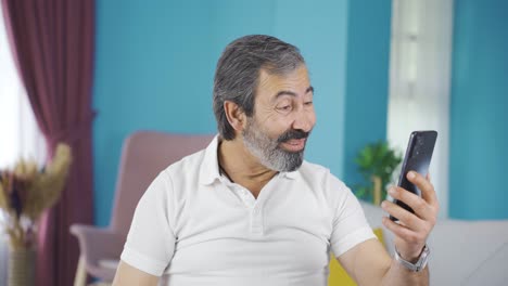 Middle-aged-man-video-chatting-with-his-grandchildren.