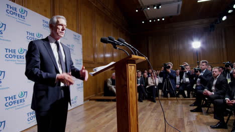 man giving a speech at a press conference