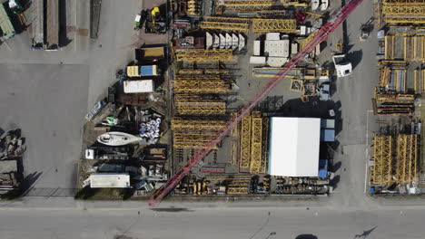 tower crane equipment storage, industrial district, descending, top down aerial