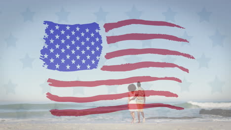 animación del diseño de la bandera de los estados unidos contra la vista trasera de una pareja afroamericana caminando en una playa