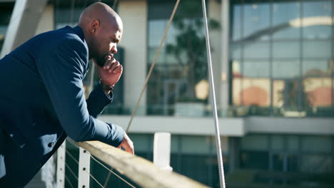 businessman contemplating on a city bridge