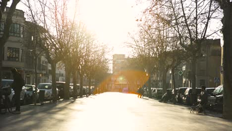 sunny city street scene with people and cars