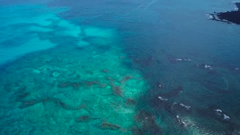 The-Big-Island-of-Hawai'i-housing-beautiful-contrasts-of-black,-green-and-blue,-all-shown-from-above-2