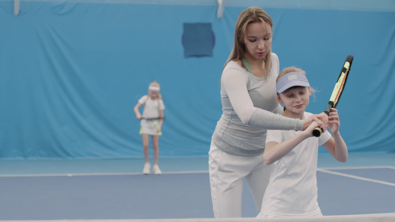 Little Girl On Tennis Training With Coach