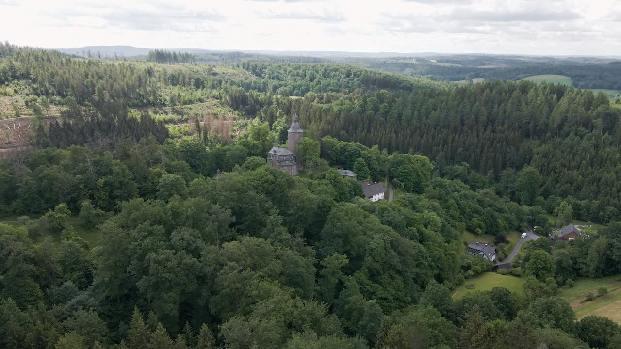 wide circular drone shot of Wildenburg Castle in the southeast of the village of Friesenhagen, in the North Rhine-Westphalia region of Germany