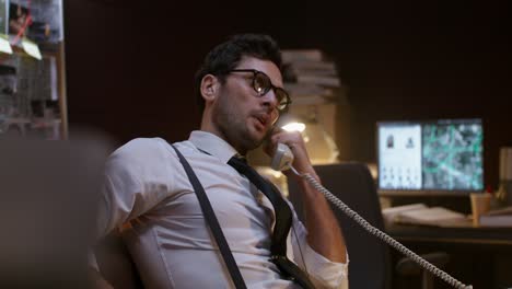 detective on a crucial phone call