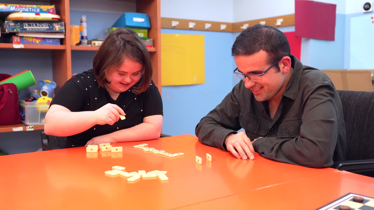 People playing dominoes at a table