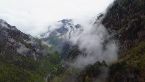 Flying-through-low-lying-clouds-in-Nemuna-National-Park,-Kosovo