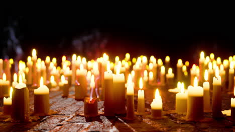 abundance of lit candles on table