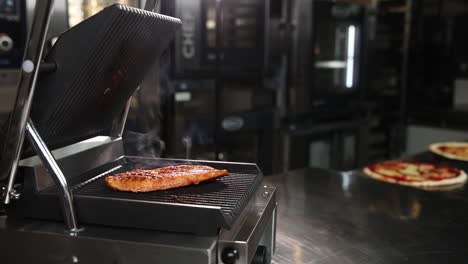 chef preparing steak on a commercial grill