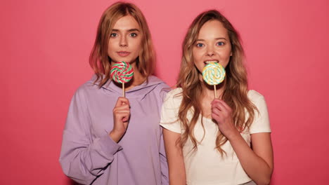 two young women with lollipops