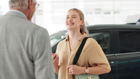 woman talking to salesperson at car dealership