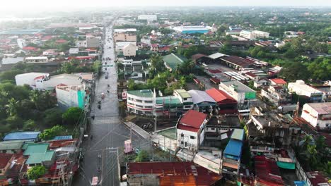 Aerial-view-of-vehicles-driving-through-long-flooded-highway-from-Dagupan-City,-Philippines