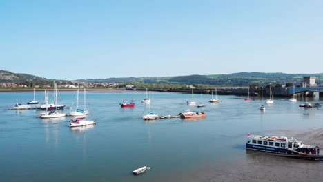 small boats on the river conwy on a clear summer's day, wales