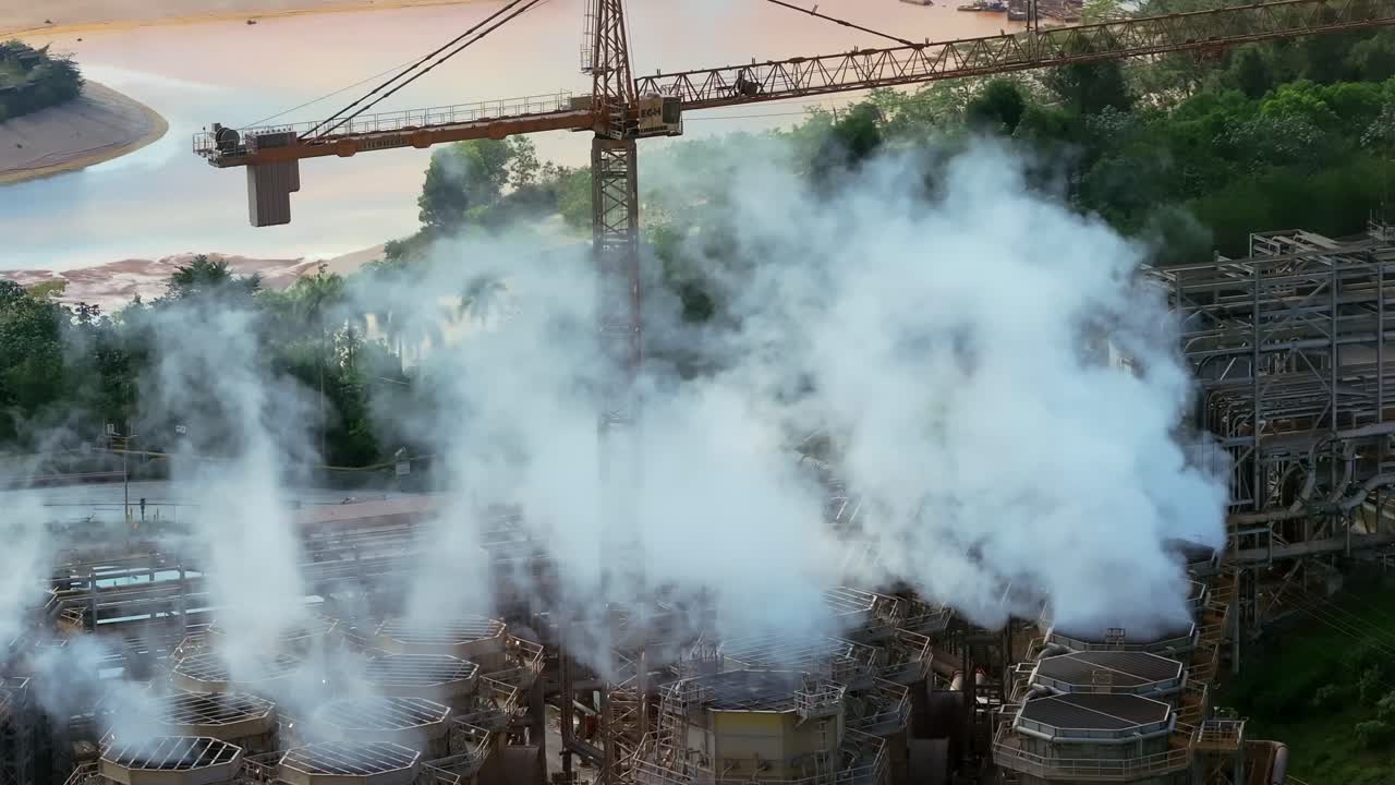 Steam rising from smokestacks, Cotui, Barrick Gold mine, Dominican Republic. Aerial drone, vertical