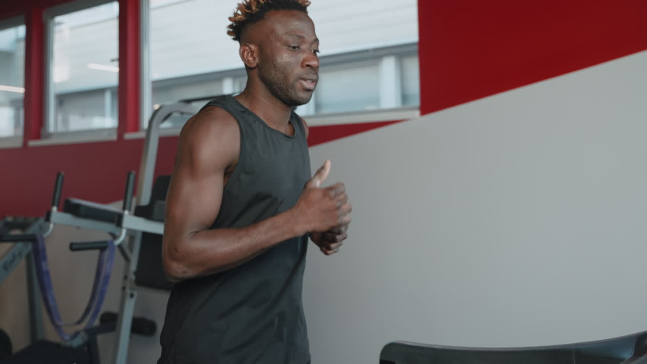 Man Running on Treadmill in Gym