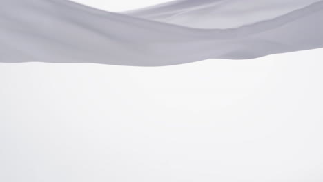 animation of white fabric blowing with copy space over white background