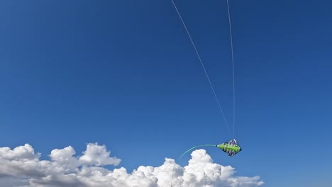 uncommon perspective of hands flying green kite by holding green handles