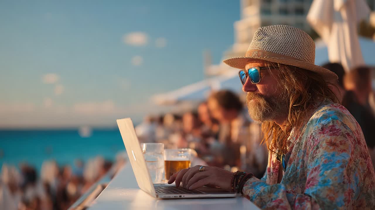A Relaxed Individual Working on a Laptop by the Beach at Sunset: The Perfect Blend of Work and Leisure Amidst a Vibrant Social Scene