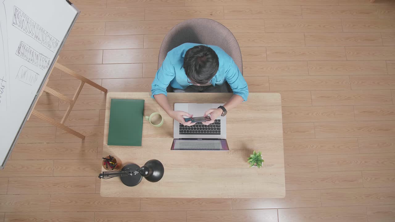 행복한 남자가 책상에서 성공을 축하하고 있습니다.