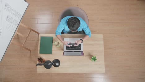 happy man celebrating success at his desk