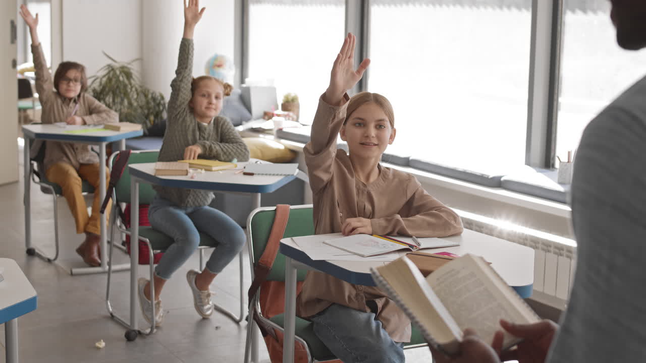 Smart Children Raising their Hands in Classroom