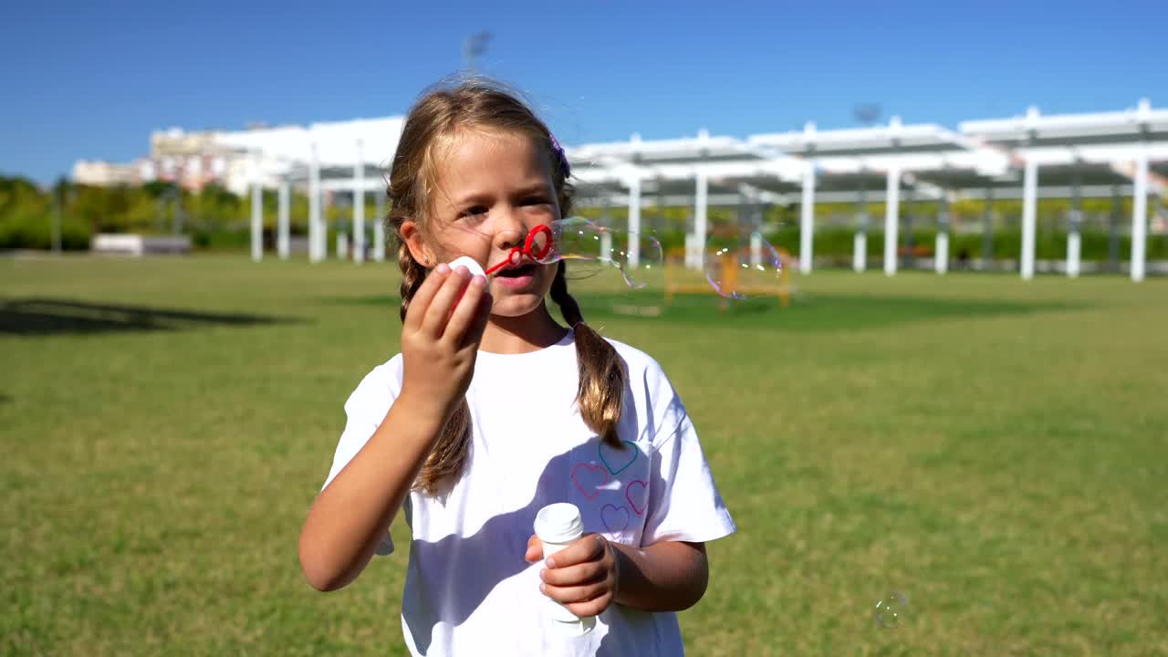 Girl blowing bubbles in the park