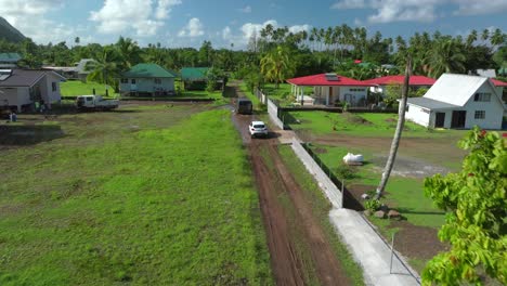 Teahupoo-Tahiti-French-Polynesia-aerial-drone-view-end-of-the-road-neighborhood-homes-van-car-drive-island-coast-to-Papeete-morning-sunny-bay-channel-coral-reef-valley-river-forward-motion