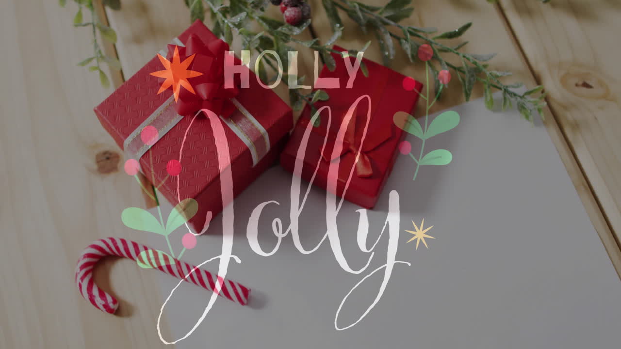 Holly Jolly text animation over Christmas gifts and candy cane on wooden surface