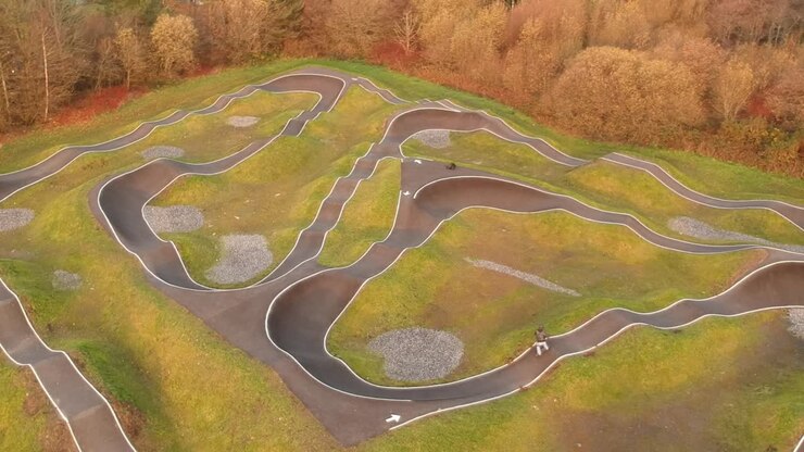 Eboarder riding around a BMX pump track