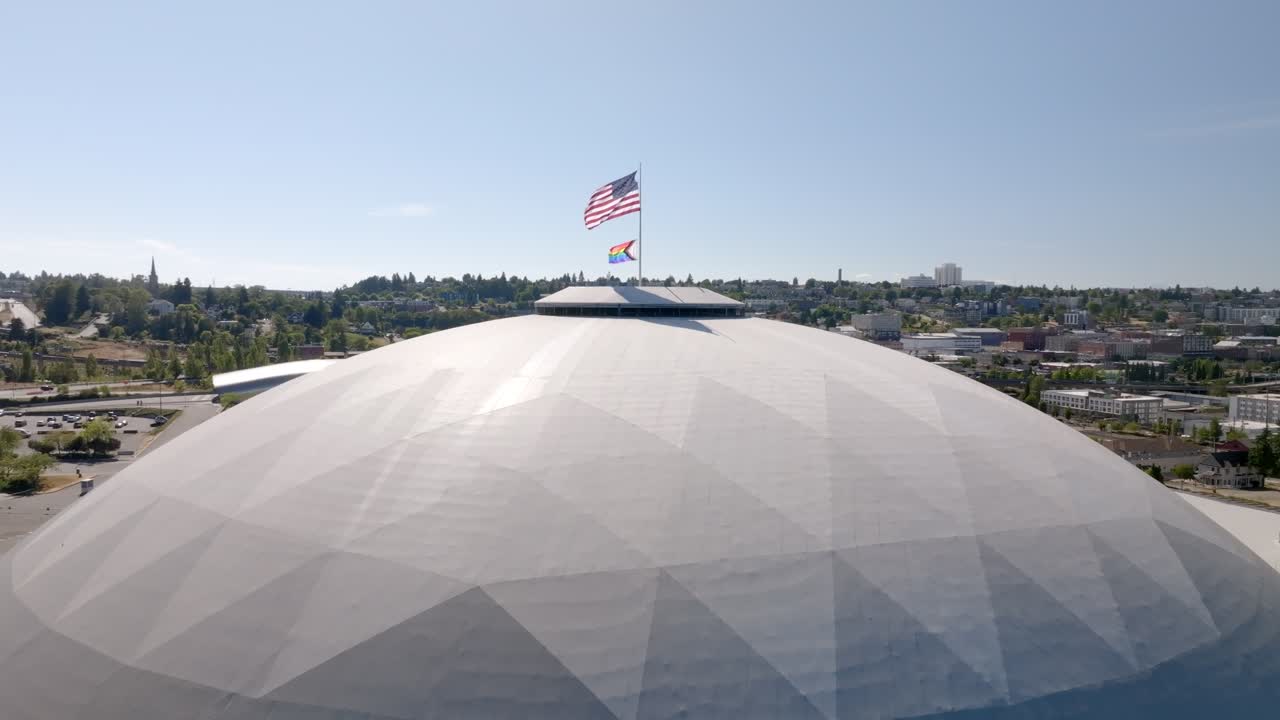 Tacoma Dome With Pride Flag And USA Flag To Celebrate And Honor The LGBTQ+ Community In Washington, USA. - aerial static shot
